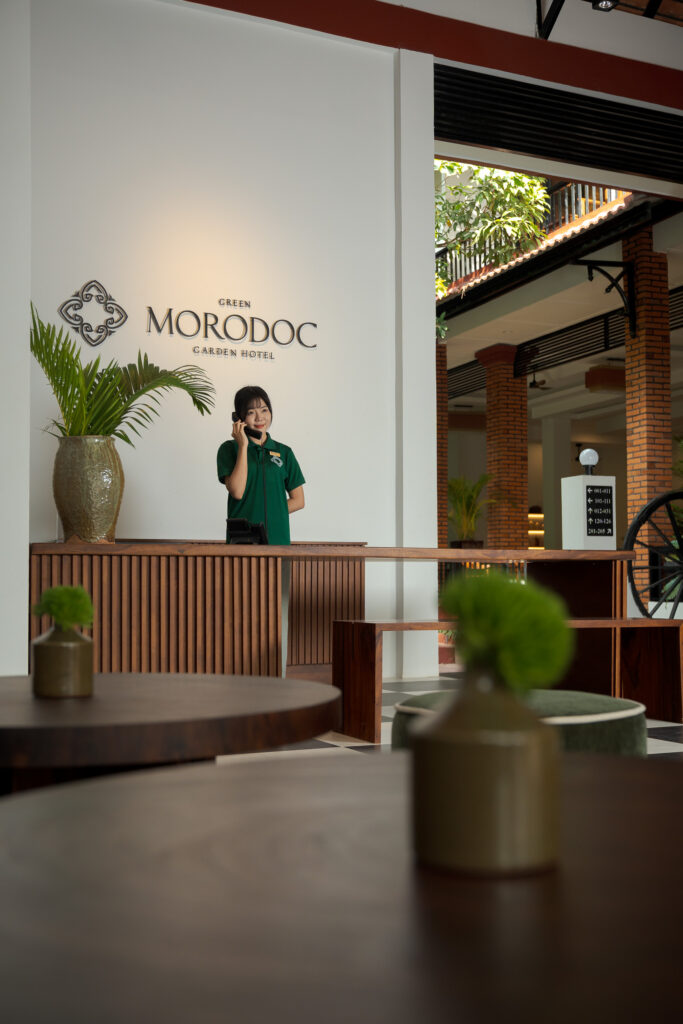 receptionist at lobby of boutique hotel in siem reap photographed by exposure photography