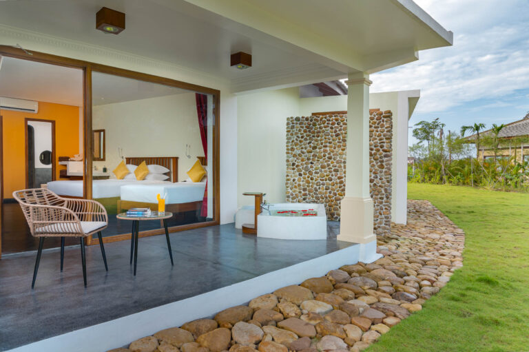 Modern hotel room in Kampot with balcony, seating area and natural light