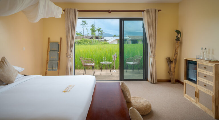Resort room in Kampot with garden view balcony and natural light – hotel photography Cambodia