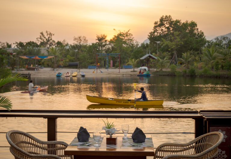 Riverside restaurant at Kampot resort during sunset with outdoor seating and river views – hotel photography Cambodia