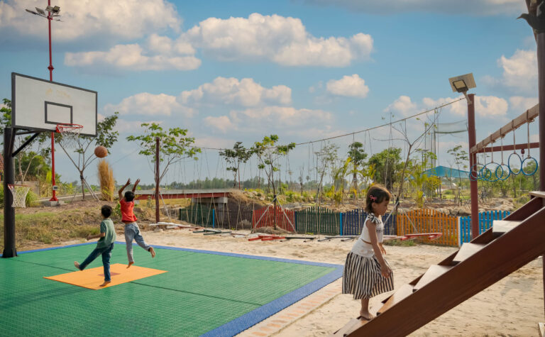 Outdoor sports and activity area at Kampot resort with guests playing on court