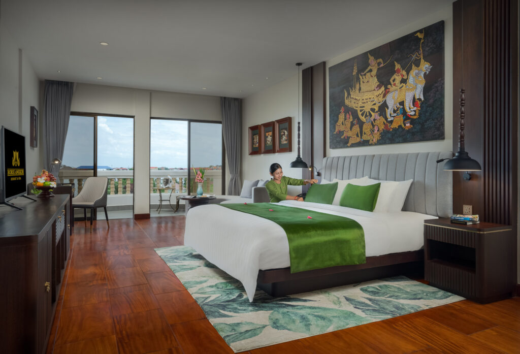 Hotel room interior with balcony view and natural light at luxury boutique hotel in Cambodia