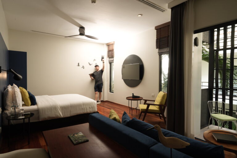 Photographer from Exposure Photography lighting a room with artificial light