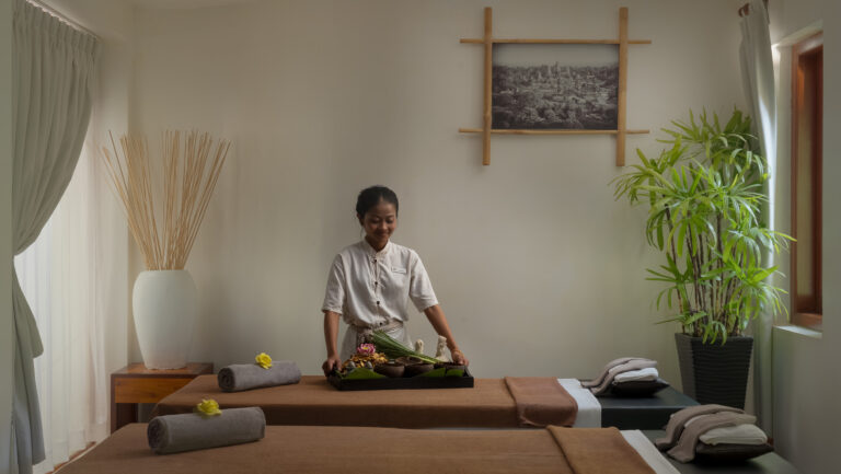 Spa therapist preparing for a massage treatment at La Rivière d'Angkor boutique hotel in Siem Reap