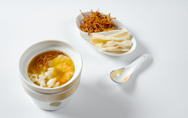 Chinese appetiser served with soup on a white background
